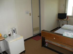 Postel nebo postele na pokoji v ubytování Business Hotel Minshuku Minato