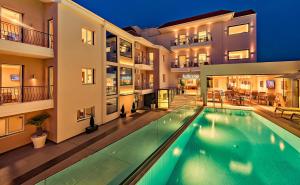 a swimming pool in the middle of a building at Kallirroe Hotel in Rio