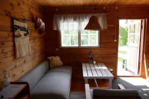 a living room with a couch and a table at Tinore Holiday Home in Muratsi