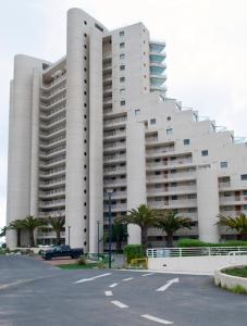 a large white building with palm trees in front of it at San Alfonso del Mar Edificio Goleta in Algarrobo