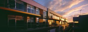 an apartment building with a sunset in the background at Adara St Kilda in Melbourne