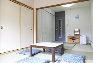 a living room with a table and a door at Hotel Angel Grandia Echigo Nakazato in Yuzawa