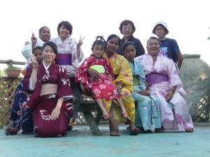 
a large group of people sitting on a bench at Soratobu Usagi in Myoko
