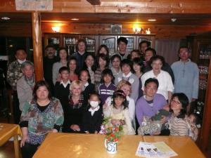
a large group of people posing for a picture at Soratobu Usagi in Myoko

