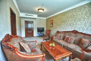 a living room filled with furniture and a fire place at Park Hotel Stara Zagora in Stara Zagora