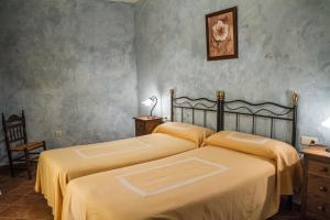 Łóżko lub łóżka w pokoju w obiekcie Aparthotel Rural 12 Caños