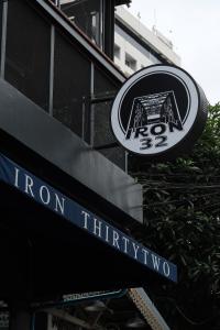 a sign for a iron thywyo restaurant on a building at Iron32 Hotel in Chiang Mai