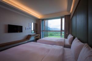 Postel nebo postele na pokoji v ubytování Taroko Liiko Hotels