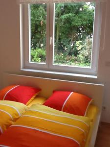 a bed with two pillows in a room with a window at Apartment Alexander Bad Kreuznach in Bad Kreuznach