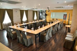 a large conference room with a long table and chairs at Ibis Jakarta Arcadia in Jakarta