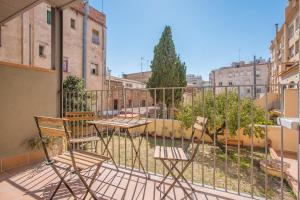 a group of chairs sitting on a balcony at Flateli- Plaça Catalunya 2-1 in Girona