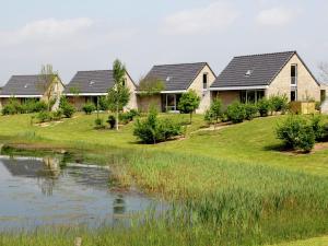 a row of houses next to a pond at Tail-Wagging Lake Escape in Heel