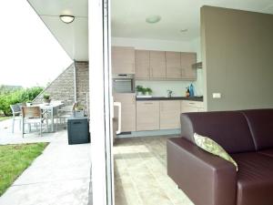 a kitchen and a living room with a couch and a table at Tail-Wagging Lake Escape in Heel +32 photos