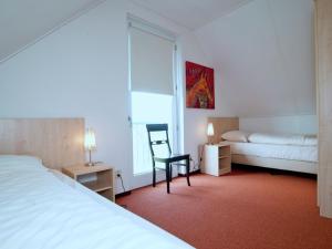 a hotel room with a bed and a chair and a window at Tail-Wagging Lake Escape in Heel