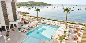 an aerial view of a resort with a pool and a beach at Nobu Hotel Ibiza Bay in Talamanca