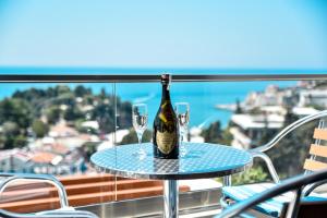 a bottle of wine on a table with two glasses at Casa Bianca & Spa in Ulcinj