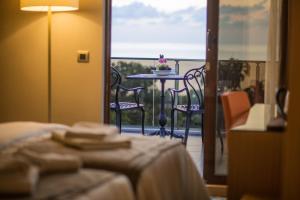 a room with a table and chairs on a balcony at Blue Sea Hotel in Trabzon