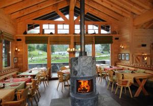 a fireplace in a restaurant with tables and chairs at Riffelalp Resort 2222m in Zermatt