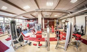 a gym with red chairs and tread machines at Hotel Everest in Węgrów