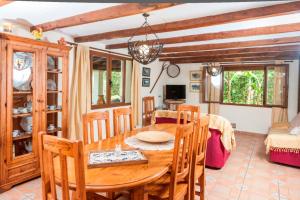 a dining room with a wooden table and chairs at Can Corro in Alcudia