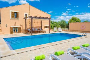 a villa with a swimming pool and a house at Can Corro in Alcudia