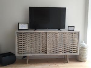 a television sitting on top of a entertainment center at Mariposa in Innsbruck