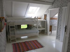 a bedroom with two bunk beds and a window at Krzywe 3 in Krzywe