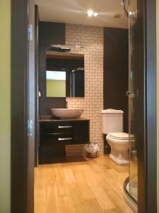 a bathroom with a sink and a toilet at Grand Plaza Mio Cid in Burgos