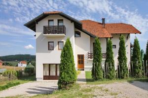 a white house with a red roof at Apartmani Bogdanović in Zlatibor