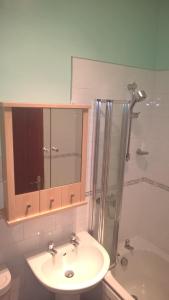 a bathroom with a sink and a shower at Crown Spa Apartment 13 in Scarborough