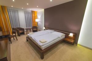 Posteľ alebo postele v izbe v ubytovaní Hotel Arkada