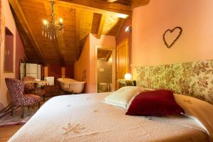 a bedroom with a large bed and a bathroom at Chambres d'Hotes Quart de Lune in Quart