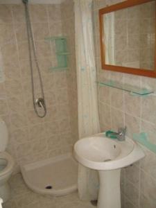 a bathroom with a sink and a toilet and a shower at Casa vacanza in Ponza