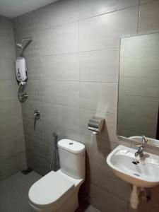 a bathroom with a toilet and a sink at Hotel Check-In in Kuala Lumpur