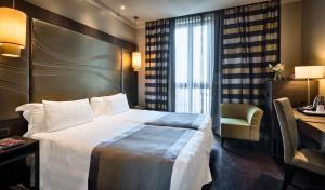 A bed or beds in a room at Uptown Palace