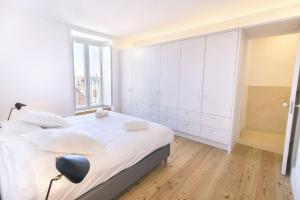 リスボンにあるLovelyStay - Luxury Oasis in Bairro Altoの白いベッドルーム(大型ベッド1台、窓付)