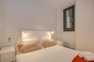 ジローナにあるFlateli Rambla de la Llibertat, 2のベッドルーム(白いベッド1台、窓付)