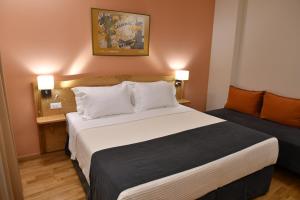 Ένα ή περισσότερα κρεβάτια σε δωμάτιο στο Onar Pension
