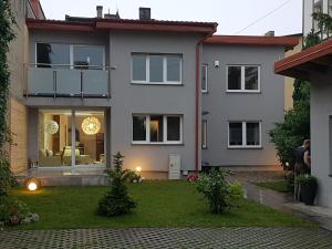 a large white house with a yard at Villa Koffi Apartments 16 plus in Puck