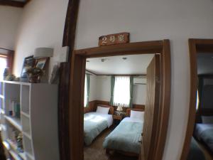 A bed or beds in a room at Pension Jokura