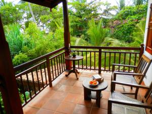 a balcony with two chairs and a table at Villa Sunrise in Tangalle
