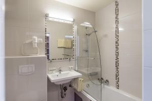 a white bathroom with a sink and a shower at Gasthof Sonne & Schnee in Kühtai in Kühtai