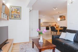 a living room with a couch and a table at City Center LUX Apartment "TONCI" in Omiš