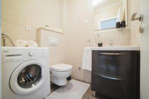 a bathroom with a washing machine and a toilet at City Center LUX Apartment "TONCI" in Omiš +21 photos