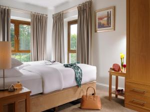 a bedroom with a bed and a window at Sneem Hotel in Sneem