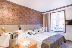 Postel nebo postele na pokoji v ubytování Grand Hotel Egersund