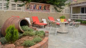 a patio with chairs and a table in front of a building at Suites Pierion Musses in Skala Potamias