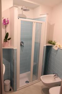 a bathroom with a shower with a toilet and a sink at Marianna Quiet Rooms in Monterosso al Mare