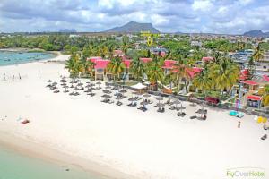 an overhead view of a beach with chairs and palm trees at Rayan Tourist Villa in Flic-en-Flac