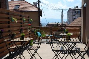 a patio with chairs and tables on a balcony at Hostel Kucha in Sarajevo